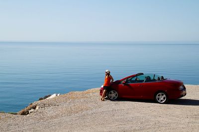 Man standing on beach against clear sky