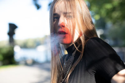 Portrait of young woman smoking