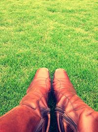 Low section of person standing on grassy field