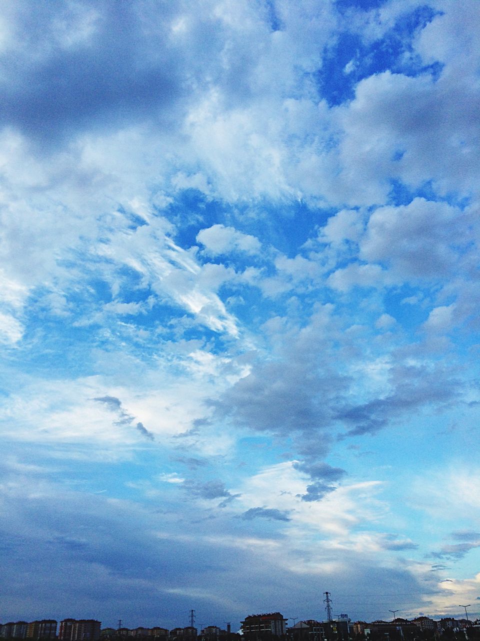 sky, cloud - sky, cloudy, scenics, beauty in nature, blue, tranquility, cloud, tranquil scene, nature, low angle view, cloudscape, weather, outdoors, no people, idyllic, day, silhouette, overcast, landscape