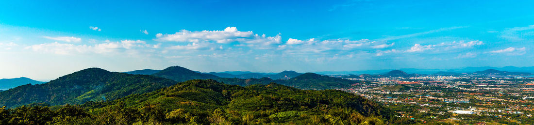 Scenic view of mountains against blue sky