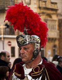 Midsection of man with red umbrella