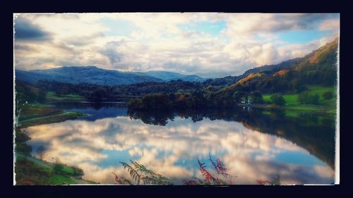 Scenic view of lake against cloudy sky