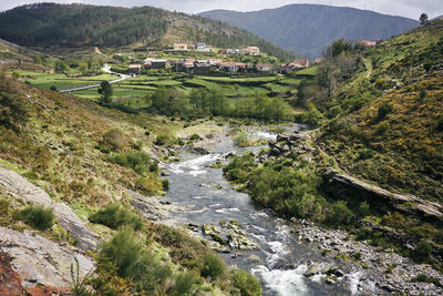 Scenic view of river by mountains