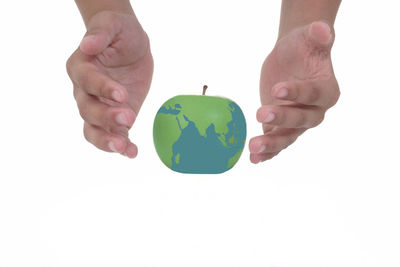 Close-up of hand holding hands over white background