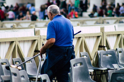 Rear view of man standing on seat