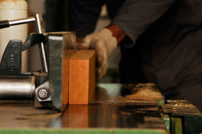 Midsection of man working in workshop