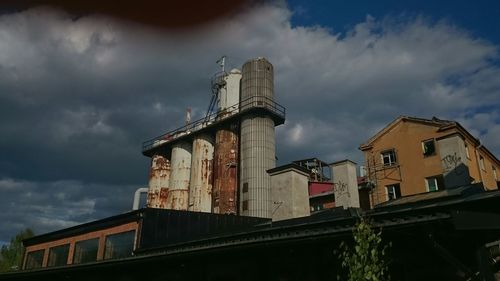 Low angle view of building against cloudy sky