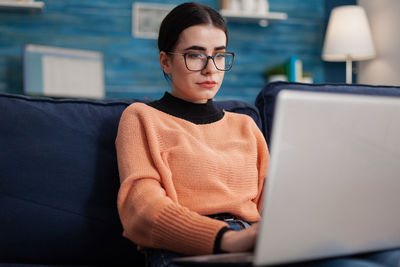 Young man using laptop at home