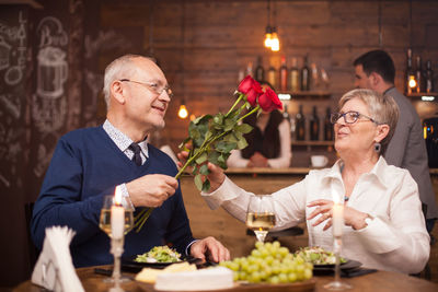 Portrait of senior couple holding food at home