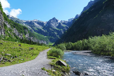 Scenic view of river amidst mountains against sky