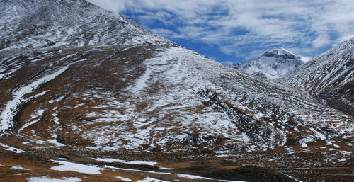 Idyllic shot of snowcapped rocky mountains against sky