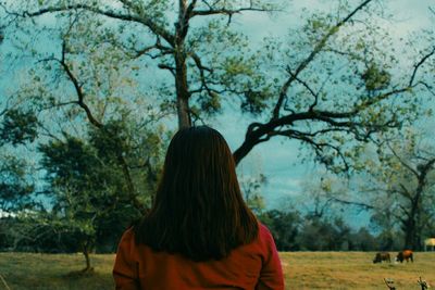 Rear view of woman standing in park