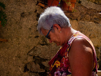 Senior woman standing outdoors