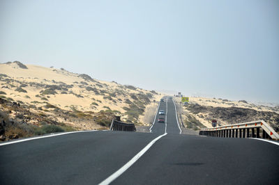 Highway in city against clear sky