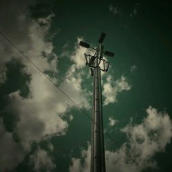 Low angle view of street light against cloudy sky