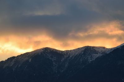 Scenic view of snowcapped mountains against sky during sunset