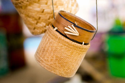 Close-up of hat hanging on wood