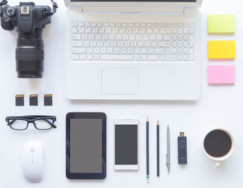 Directly above shot of laptop and coffee cup on table