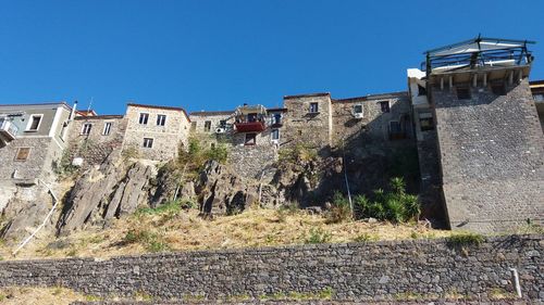 Low angle view of castle against clear blue sky