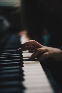 Midsection of person playing piano