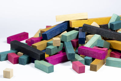 High angle view of multi colored toys against white background