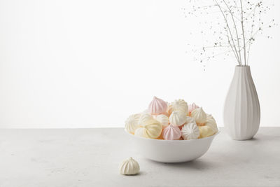 Close-up of ice cream on table against white background