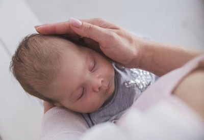 High angle view of baby boy lying on bed at home