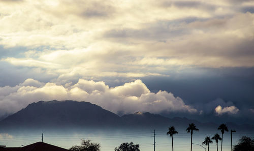 Scenic view of mountains against cloudy sky