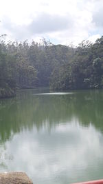 Calm lake against mountain range