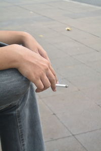 Man holding cigarette in hand