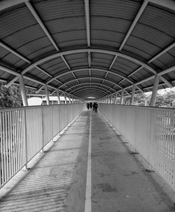 Rear view of people walking in modern corridor