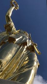 Low angle view of statue against sky