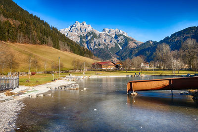 Scenic view of lake and mountains against sky