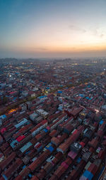 Aerial view of townscape against sky during sunset