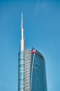 Low angle view of modern building against clear blue sky