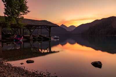 Scenic view of lake against orange sky