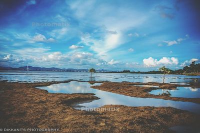 Scenic view of lake against cloudy sky