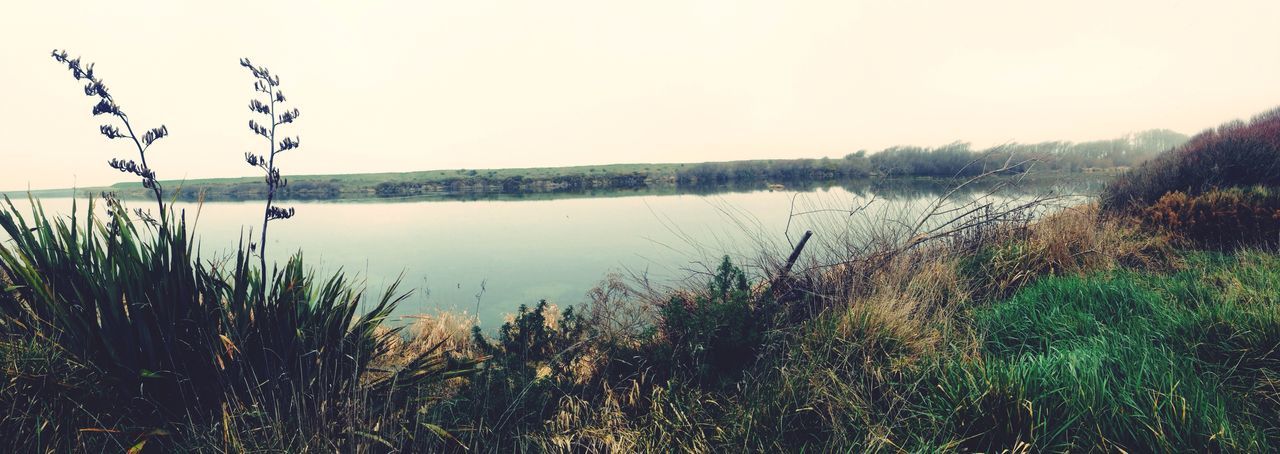 SCENIC VIEW OF CALM LAKE AGAINST SKY