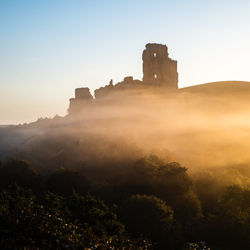 Old ruined castle against cloudy sky