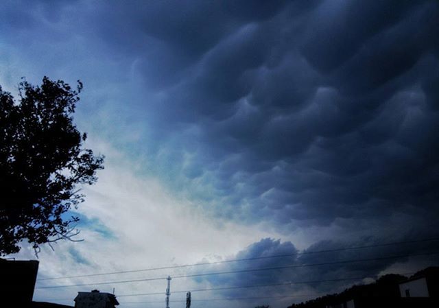 sky, cloud - sky, silhouette, low angle view, cloudy, tree, beauty in nature, cloud, scenics, tranquility, nature, weather, tranquil scene, power line, dusk, built structure, outdoors, overcast, no people, building exterior