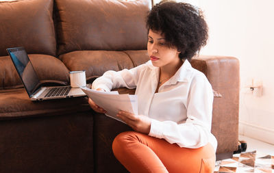 Young woman using laptop at home