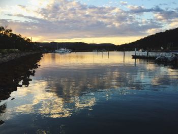 Scenic view of lake against sky at sunset