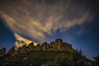 Scenic view of mountains against sky at night