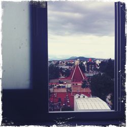 Buildings against cloudy sky