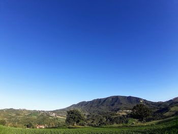 Scenic view of mountains against clear blue sky