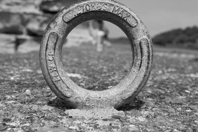 Close-up of rusty chain on field