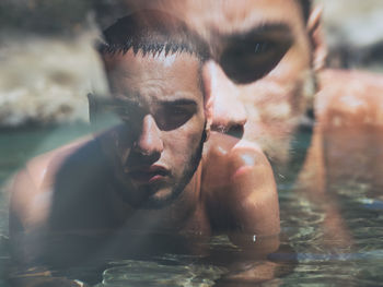 Double exposure of man in water