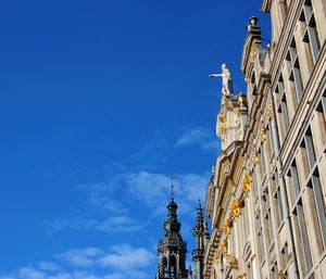 Low angle view of buildings against blue sky