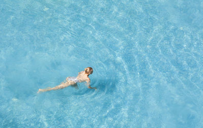 High angle view of woman swimming in sea